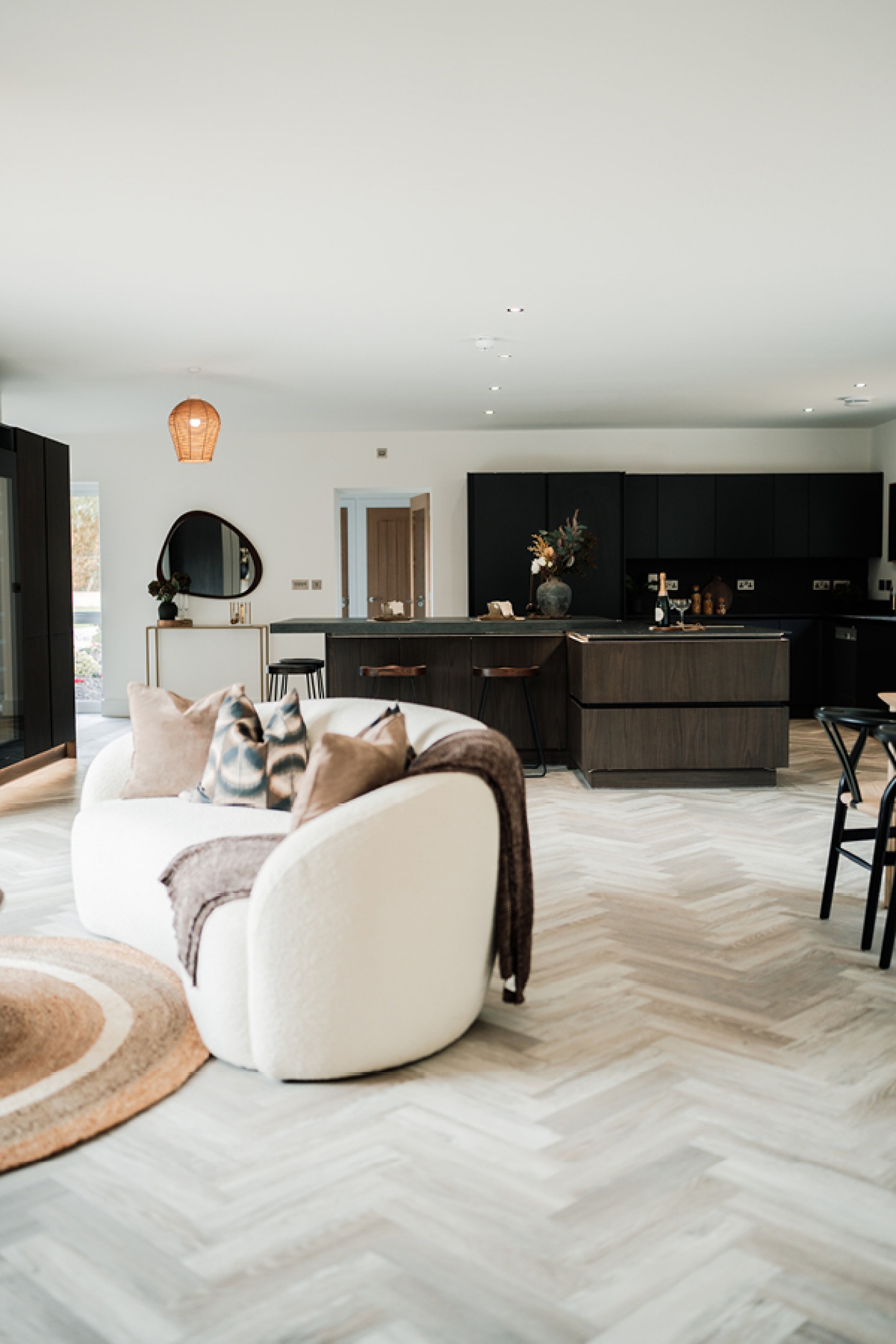Large open plan contemporary kitchen diner with a cream sofa