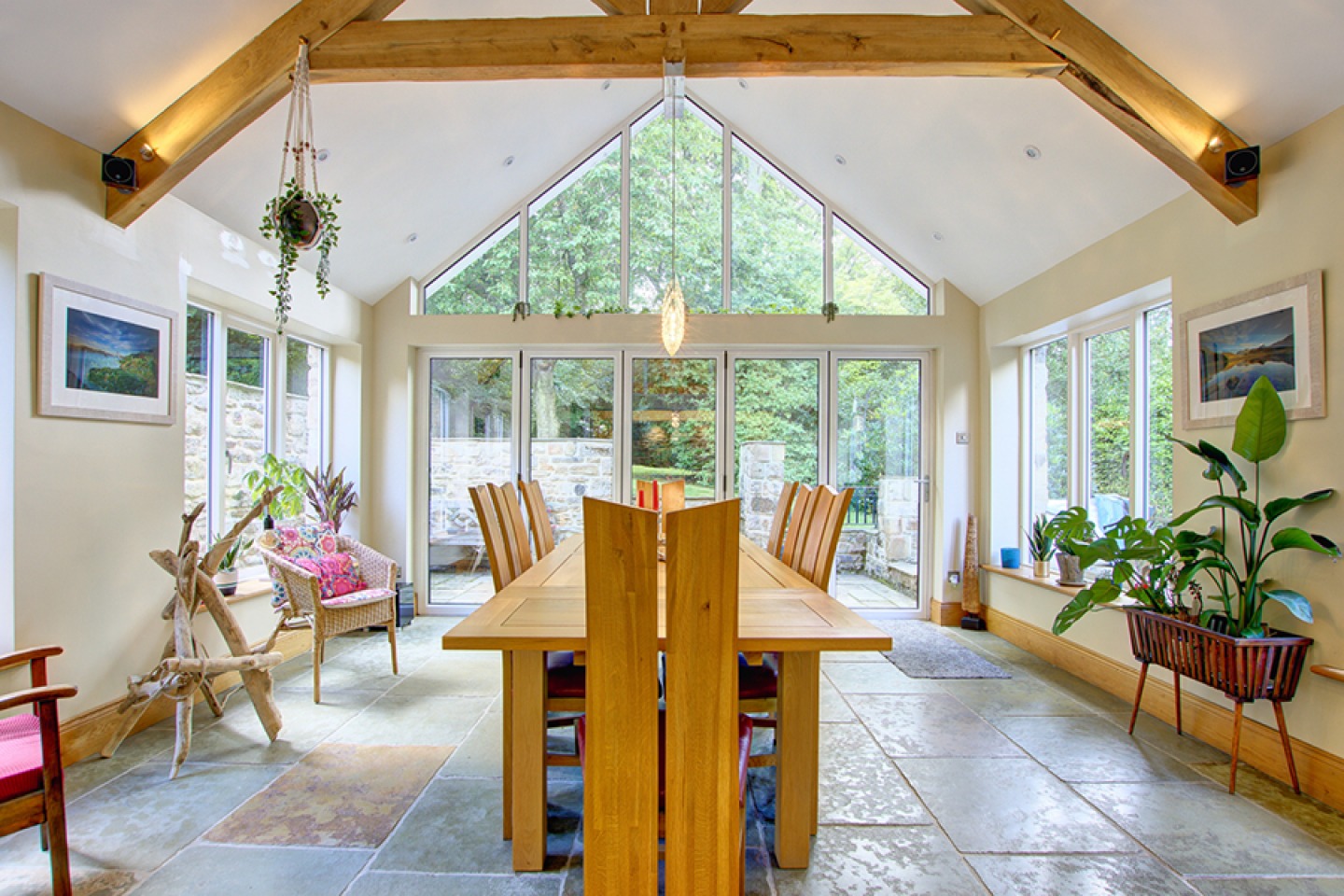 Dining room with vaulted ceiling, exposed beans and floor to ceiling feature window
