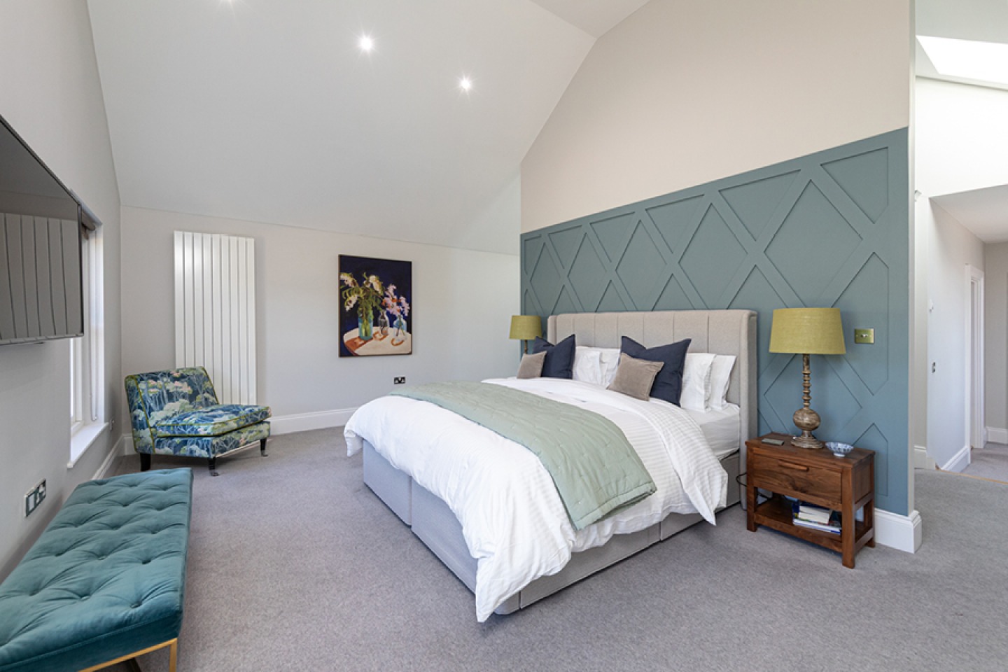 Contemporary master bedroom with teal coloured panelling