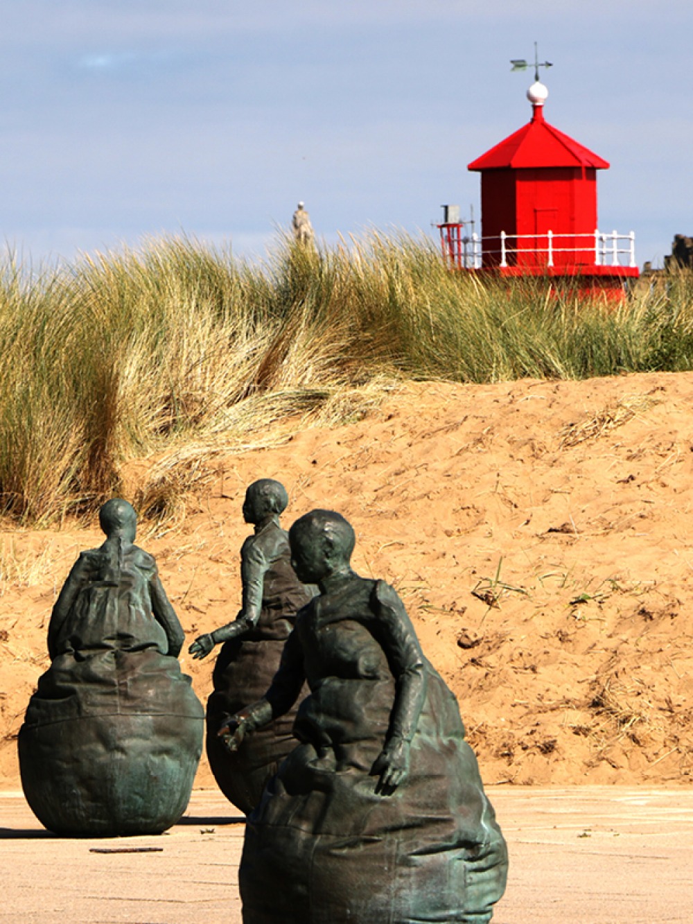The Weebles sculptures in front of sand dunes