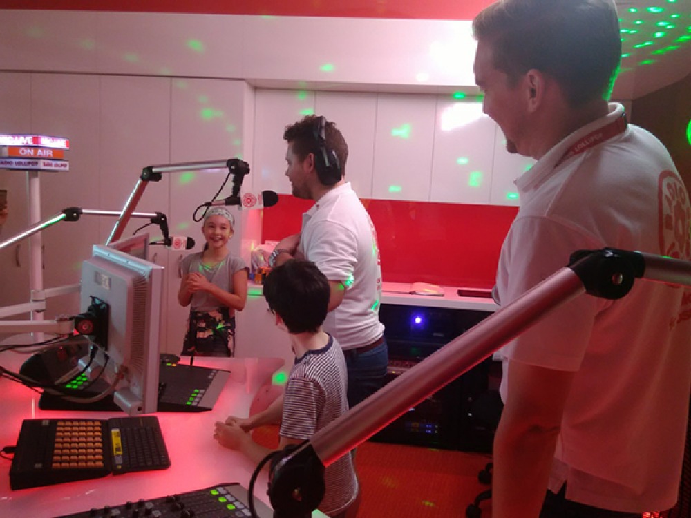 2 children and 2 volunteers in the radio Lollipop studio