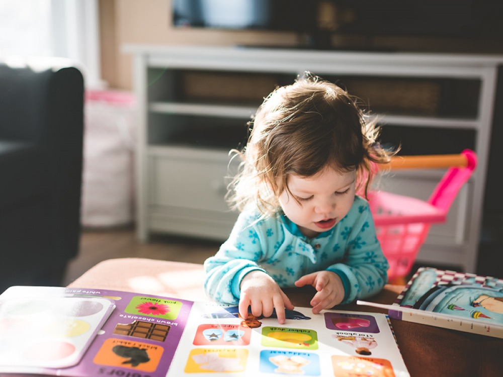 toddler looking at a book