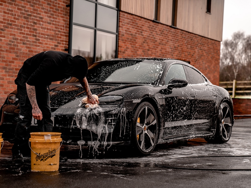 black car getting washed by hand