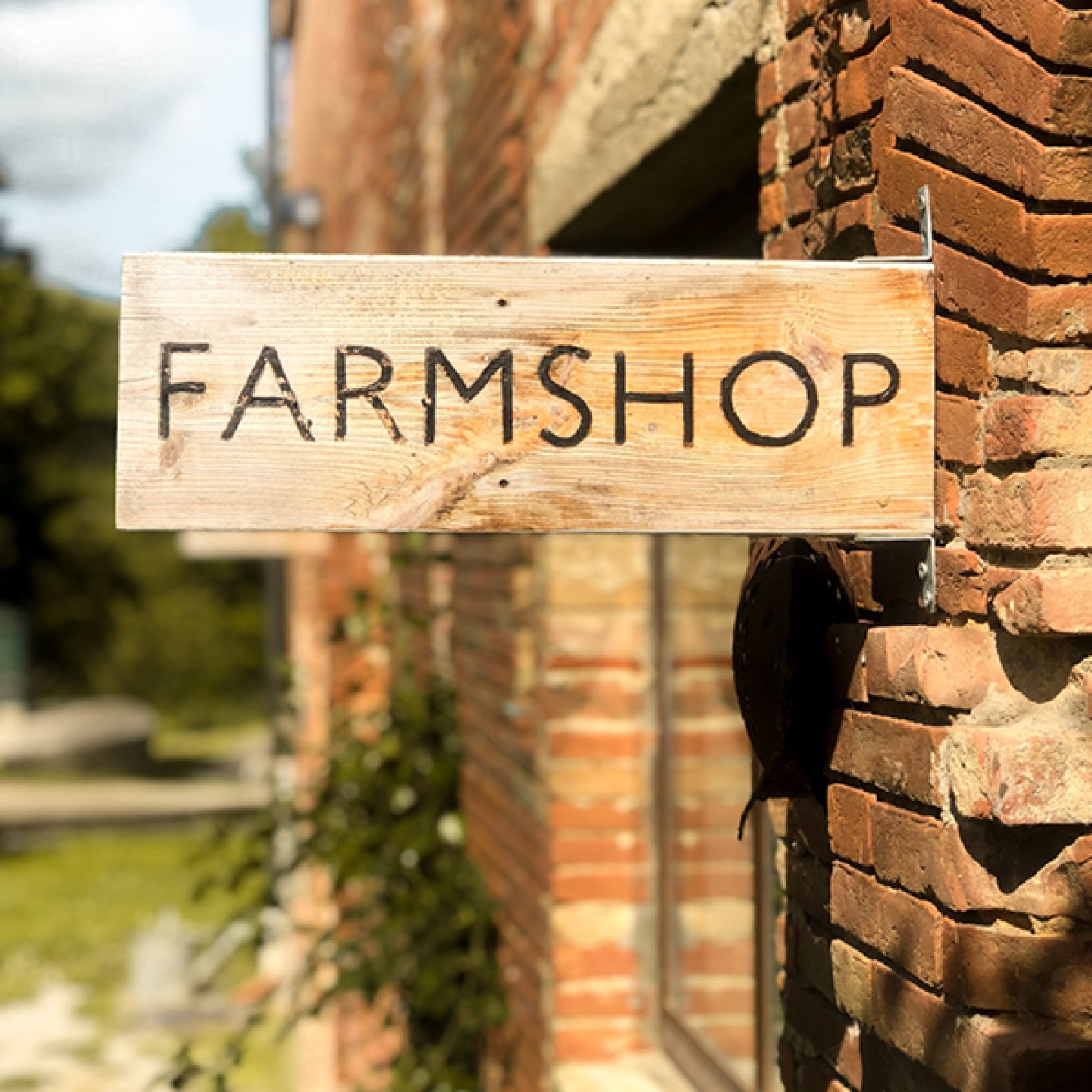 farmshop sign on brick building