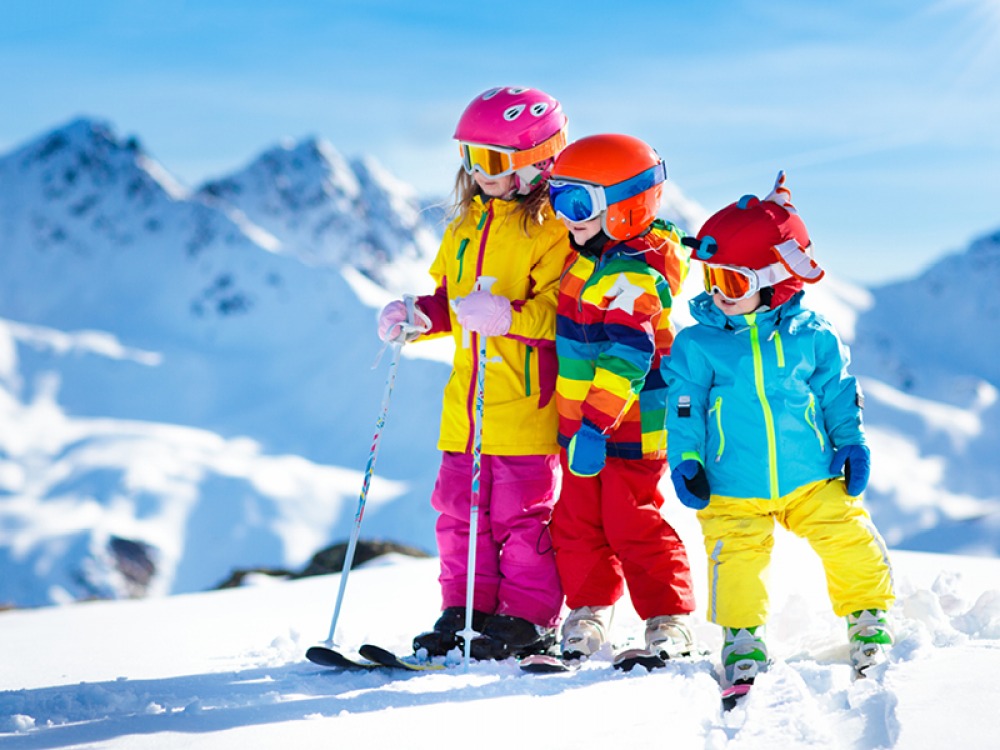3 children on a ski slope 