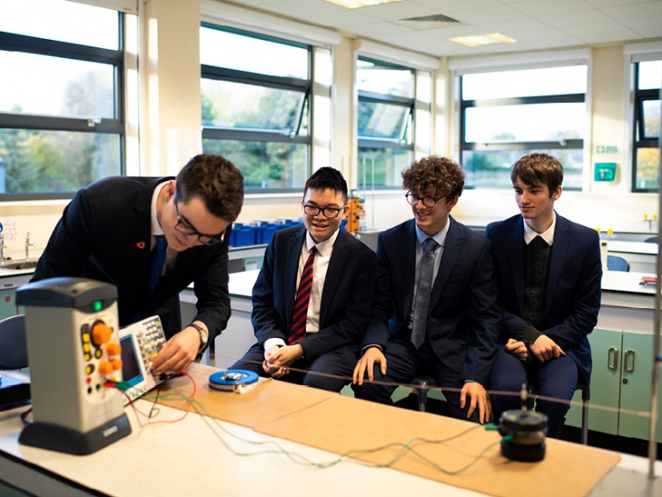4 boys working on an experiment
