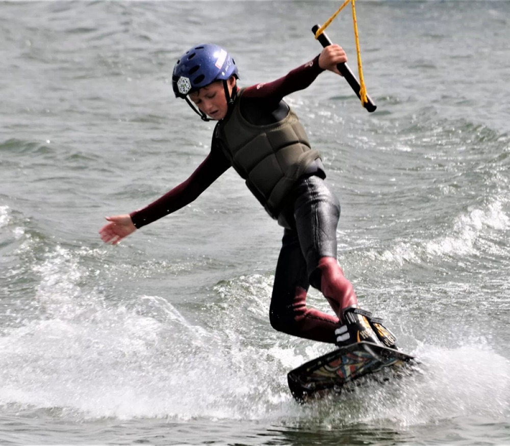 Young boy wakeboarding