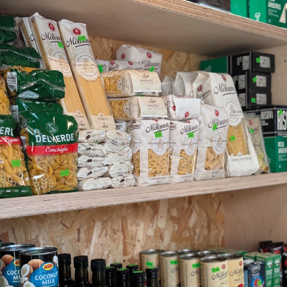 Tired food and tins on wooden shelves