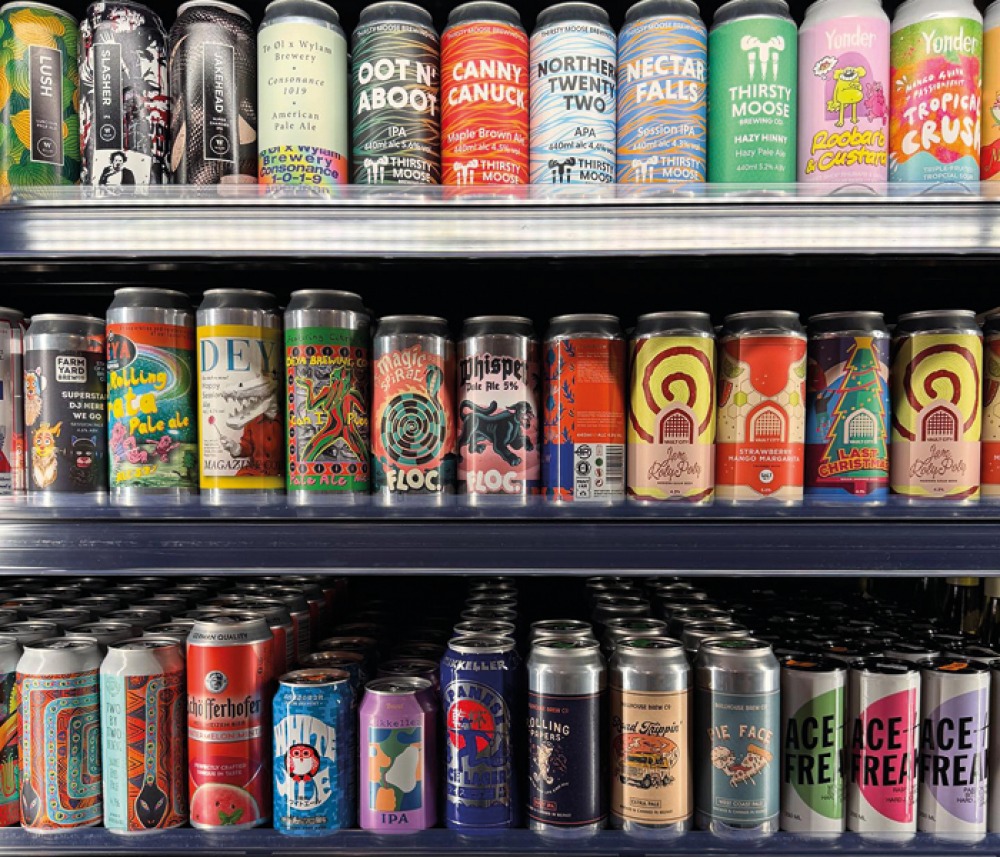 Cans of crafts beers stacked in fridge shelves