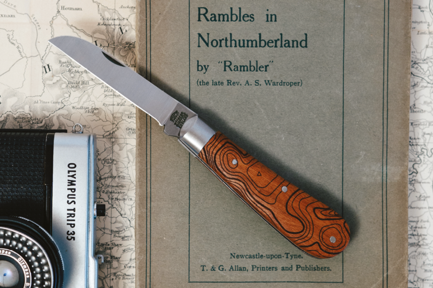 Map with a ramblers book camera and knife 