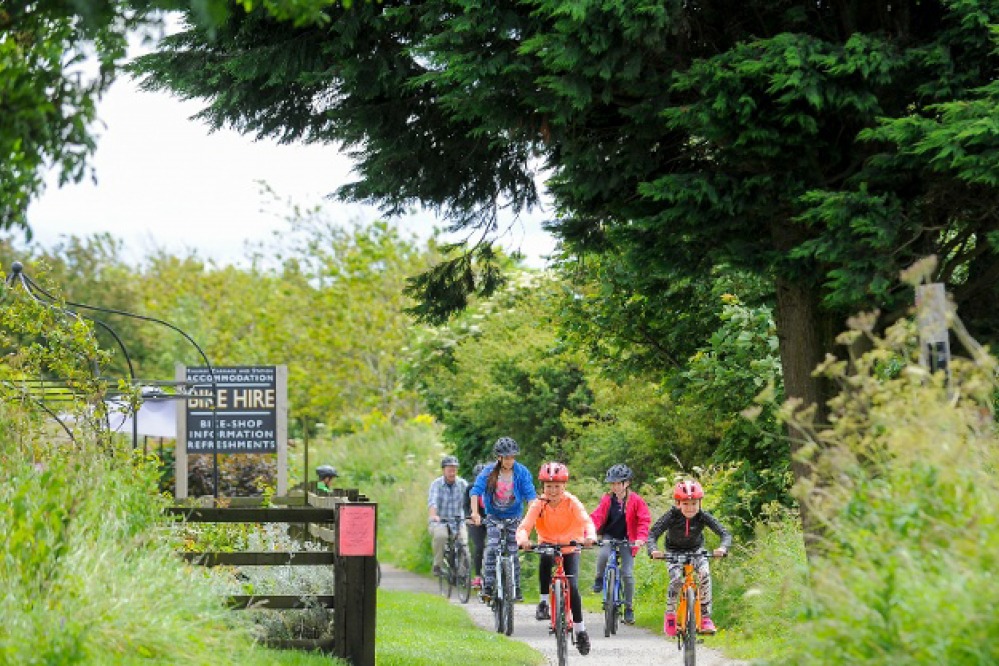 Family riding bikes on the Cinder Track