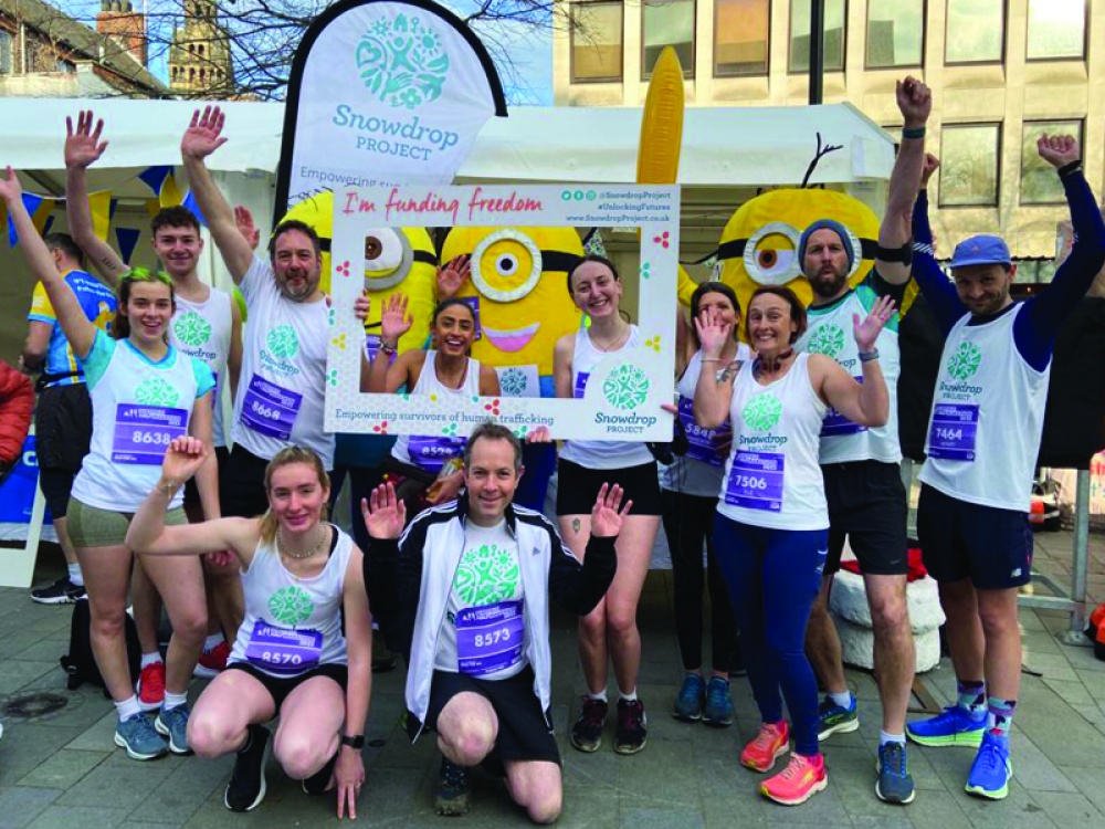 group of people posing for a charity run
