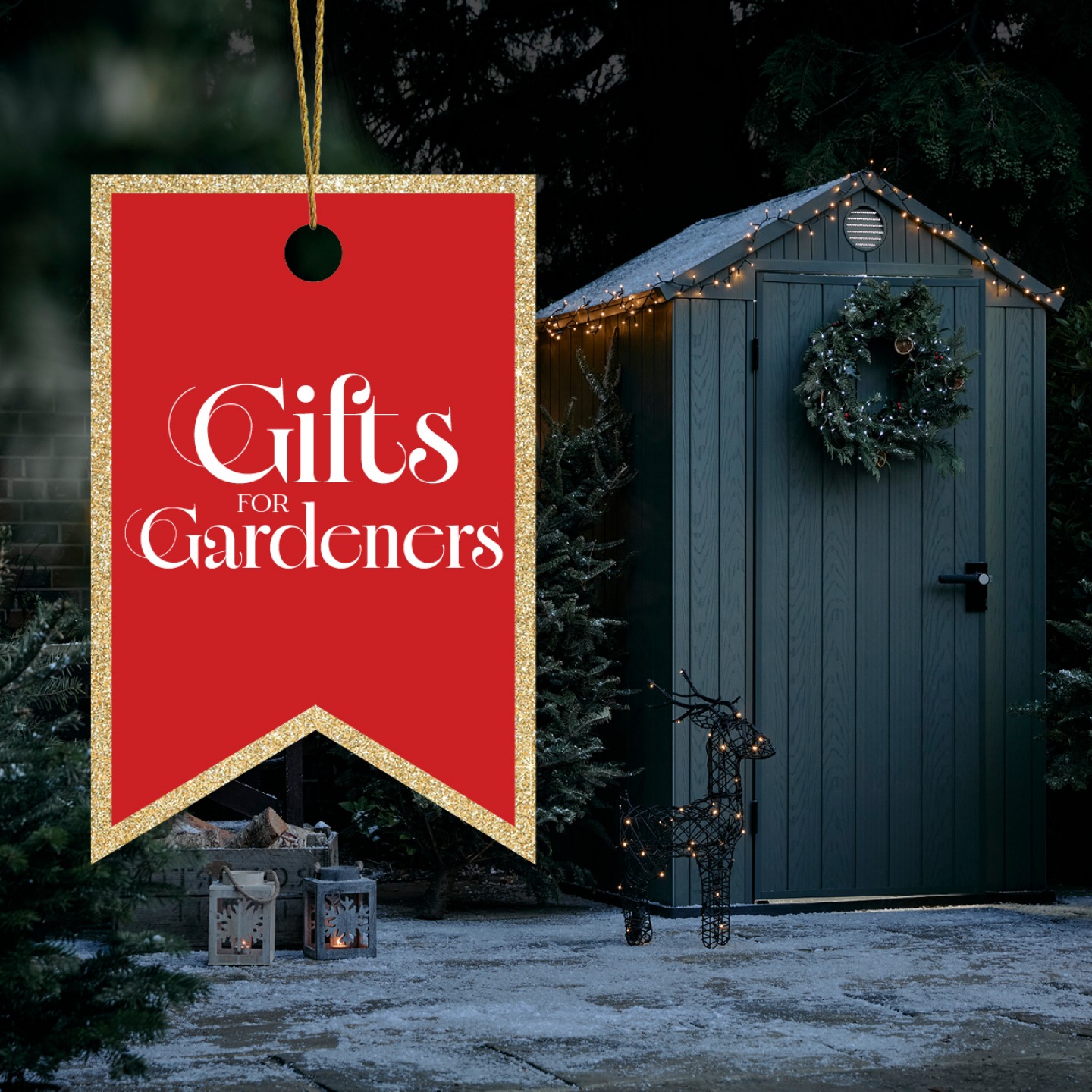 Garden shed in Winter with snow fall, wicker reindeer and Christmas lights