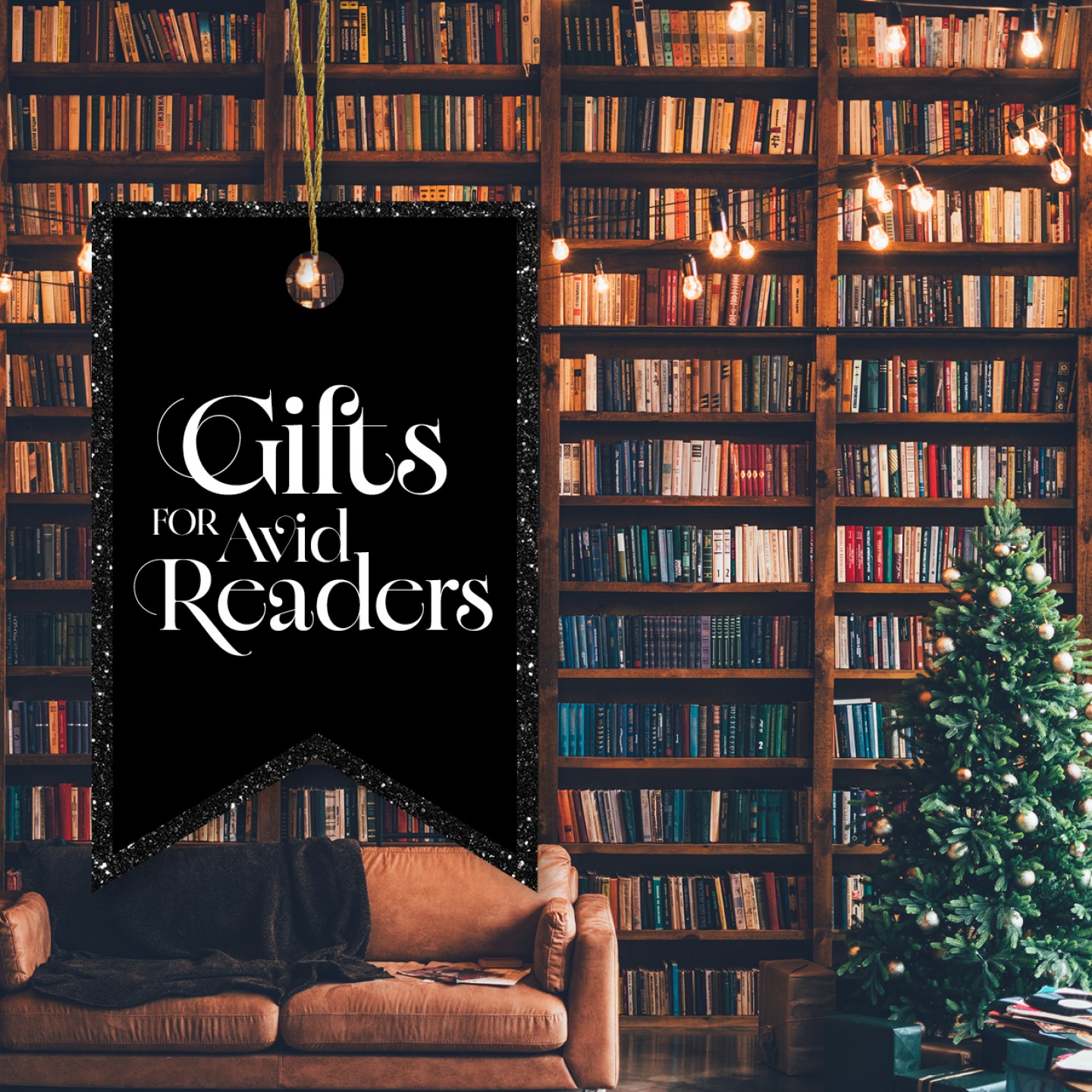 Floor to ceiling bookshelves with a Christmas tree, sofa and lights strung above