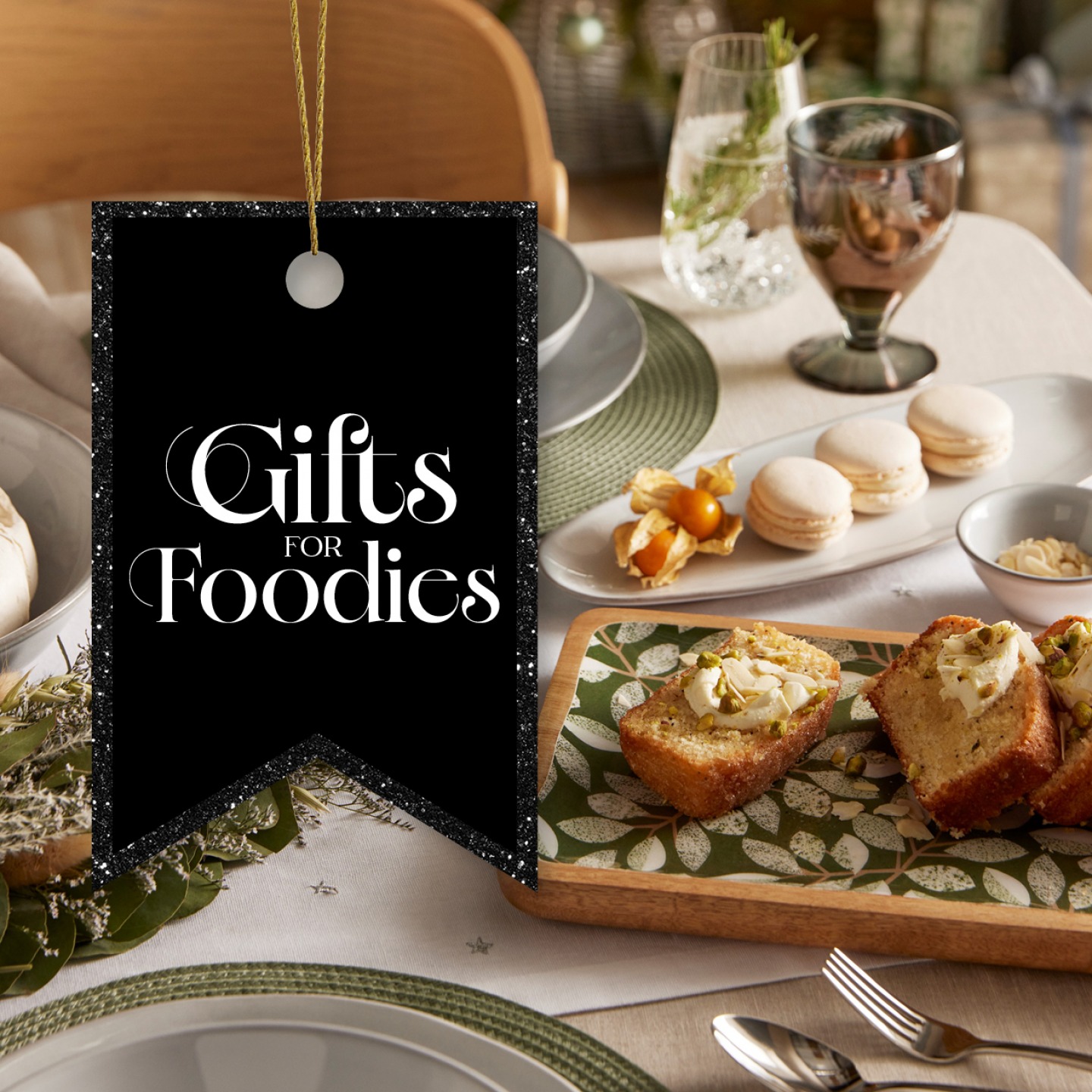 Table set with white and green tableware, loaf cafe and macaroons