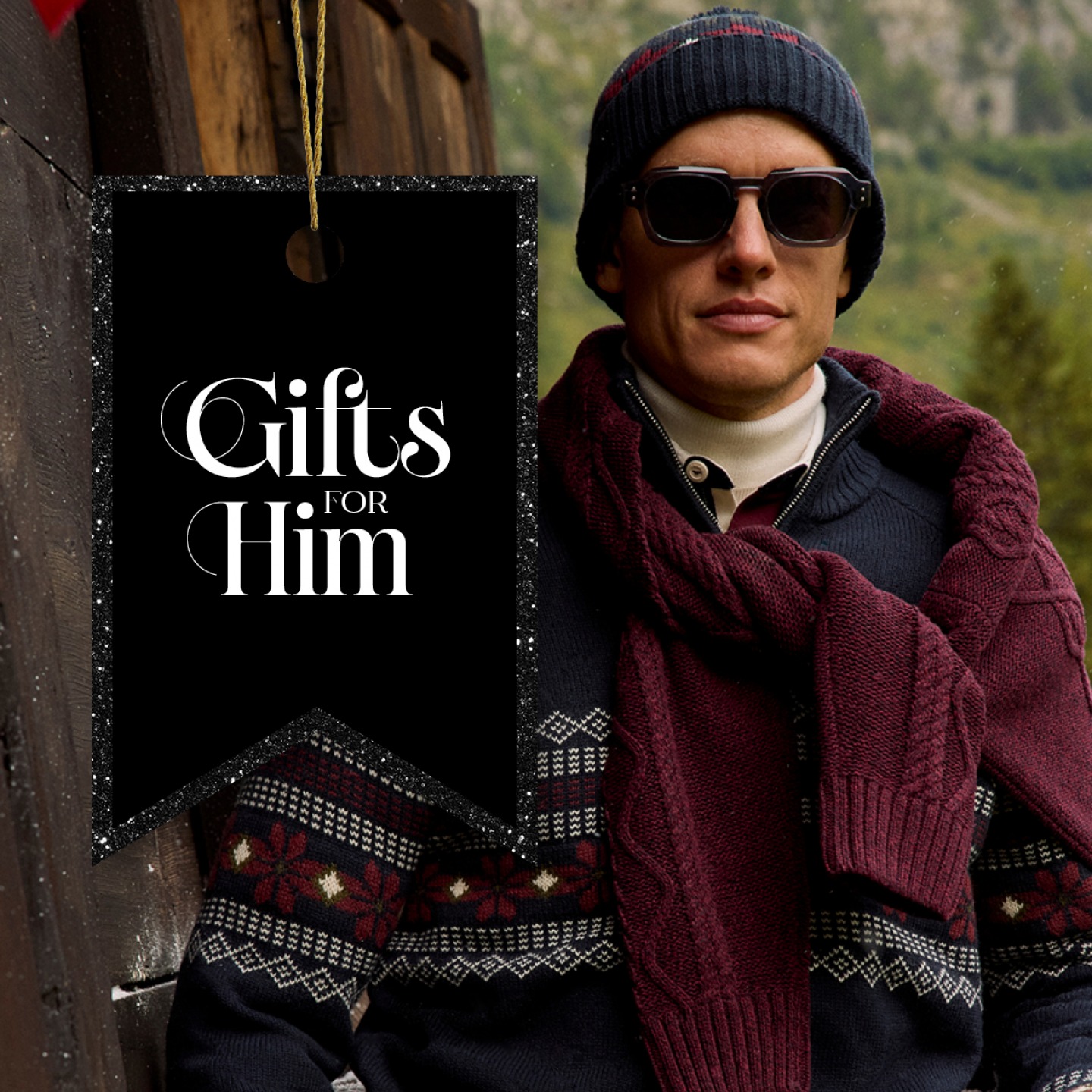 Man wearing knitted jumper around his shoulder and wooly hat with sunglasses