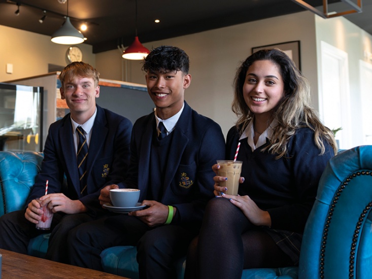 3 students sitting having refreshments