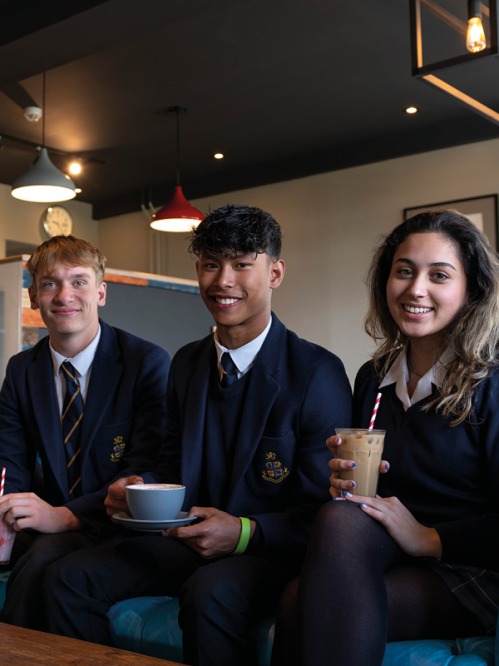 3 students sitting drinking coffees