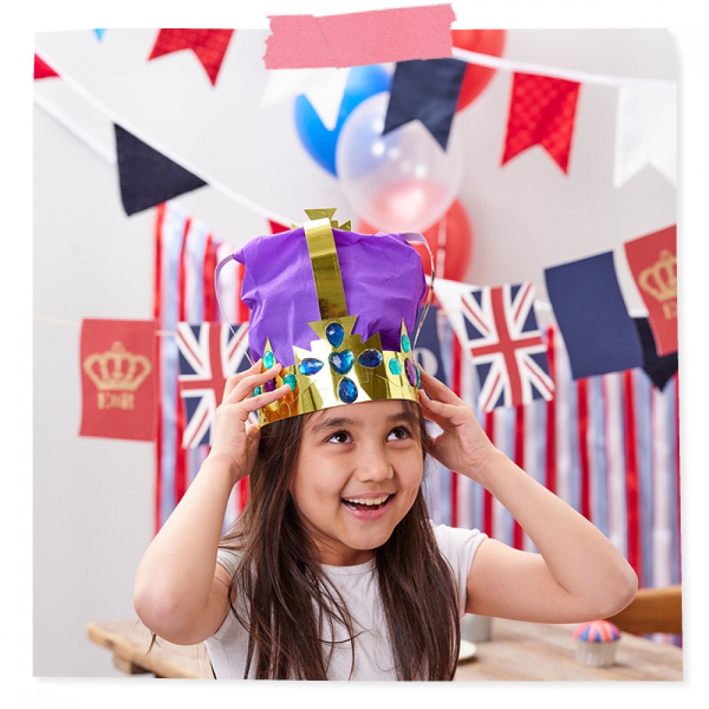 little girl wearing her handmade gold paper crown