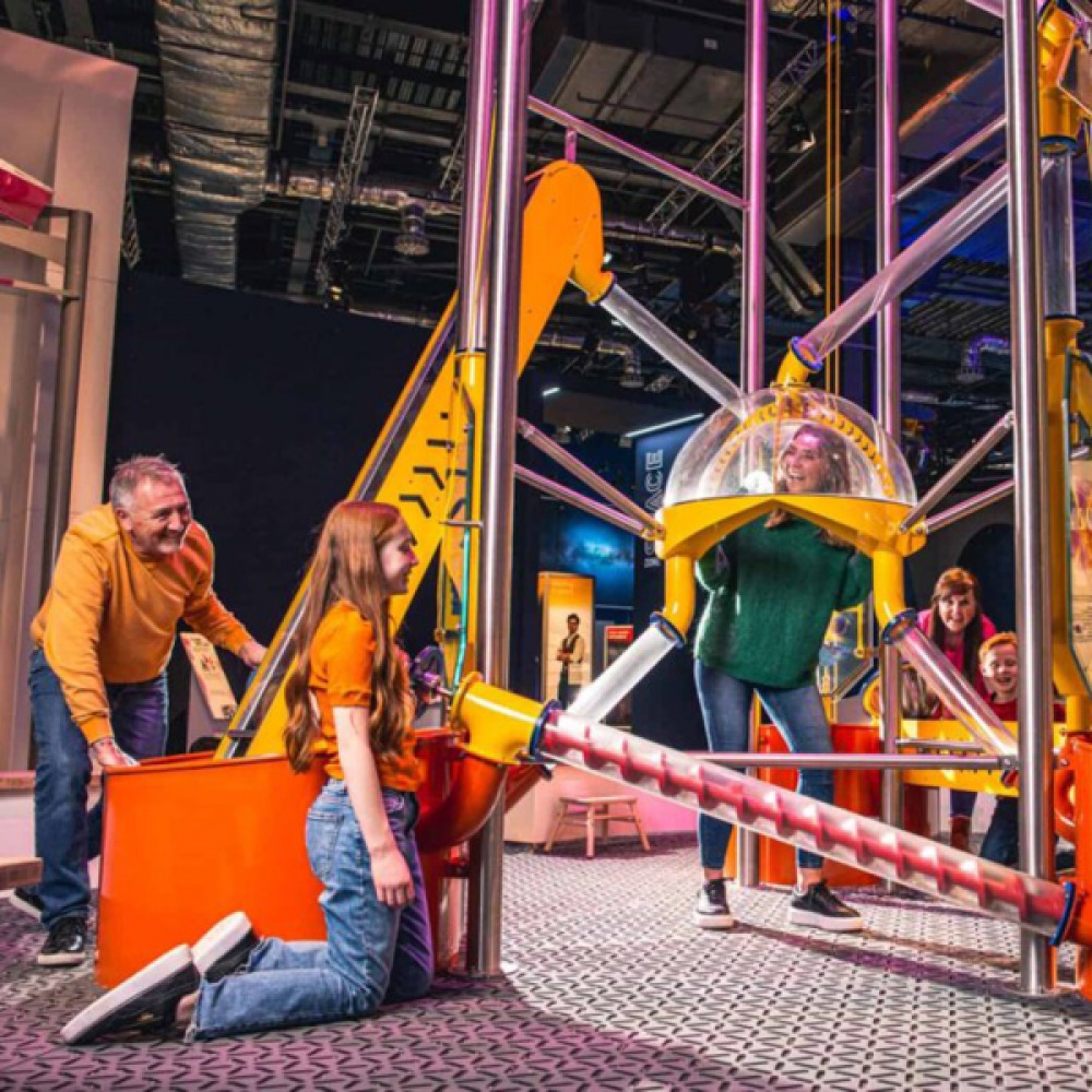 A family playing in the interactive exhibition at Life Science Centre
