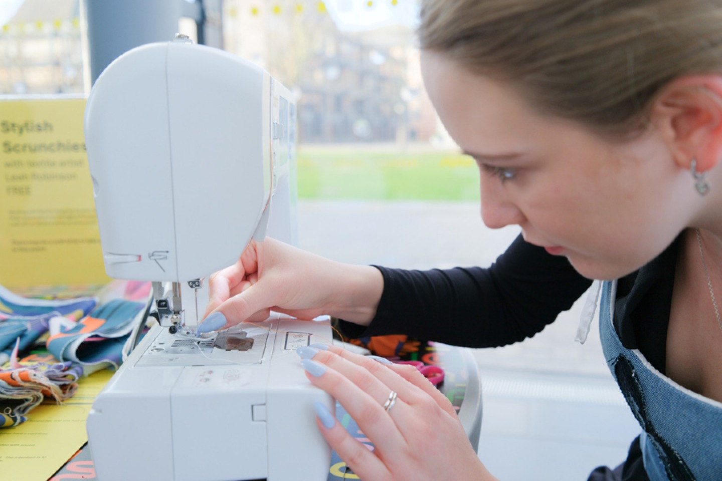 young girl sewing