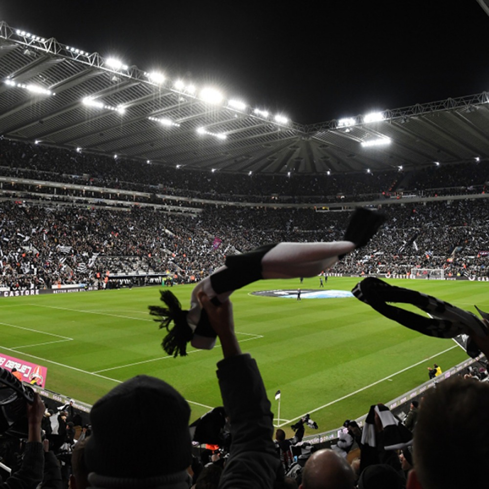 football fan waving a scarf above his head