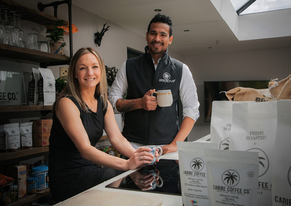 man and woman drinking coffee with Caribe Coffee
