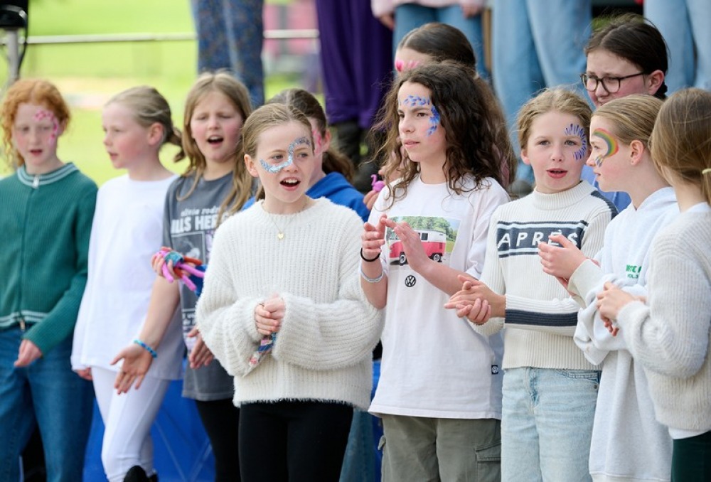 Young girls lined up with faces painted