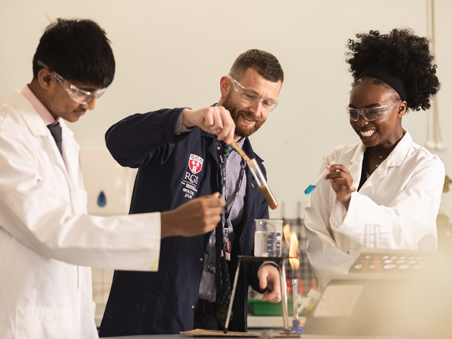 teachers and students carrying out chemistry experiments