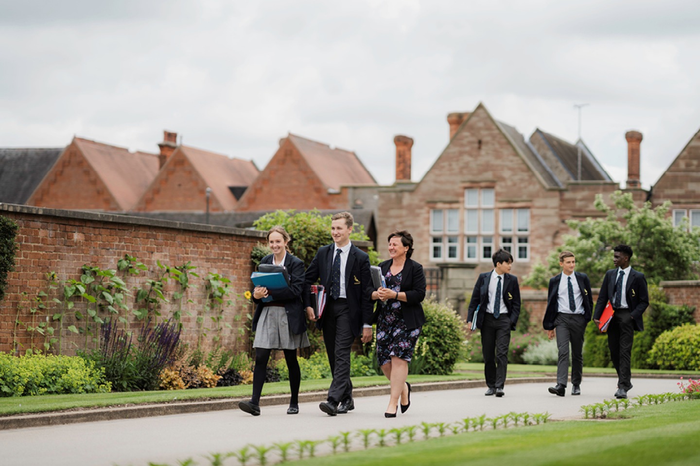 Pupils walking with a teacher through the grounds at Repton School