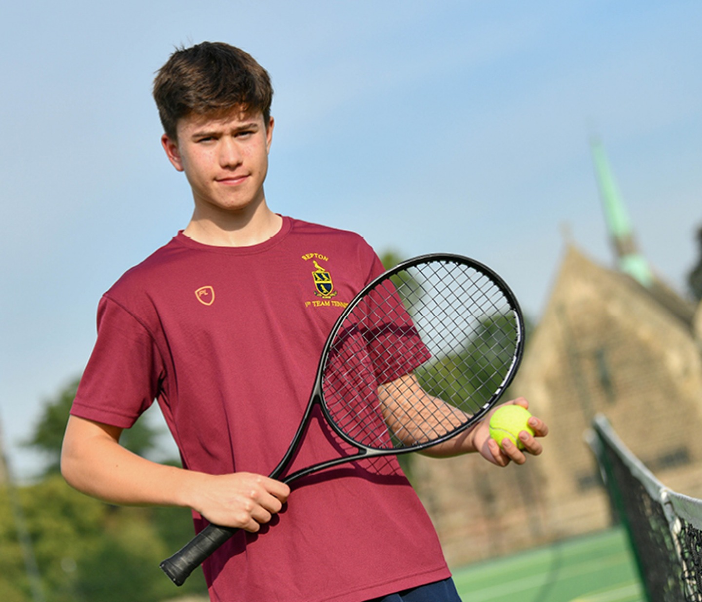student Harry Spear playing tennis