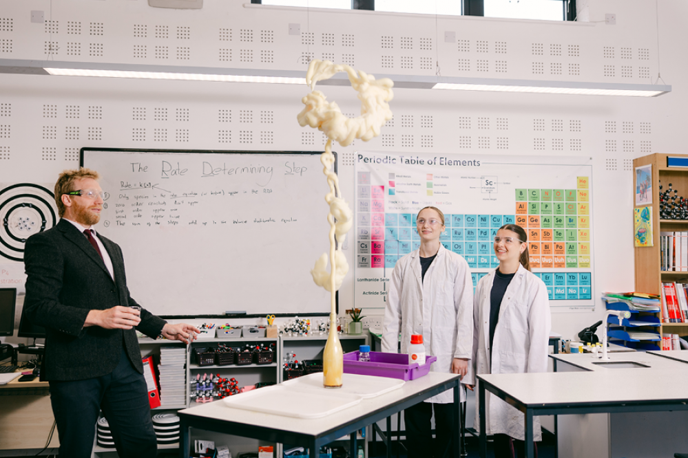 teacher with 2 pupils doing a science experiment