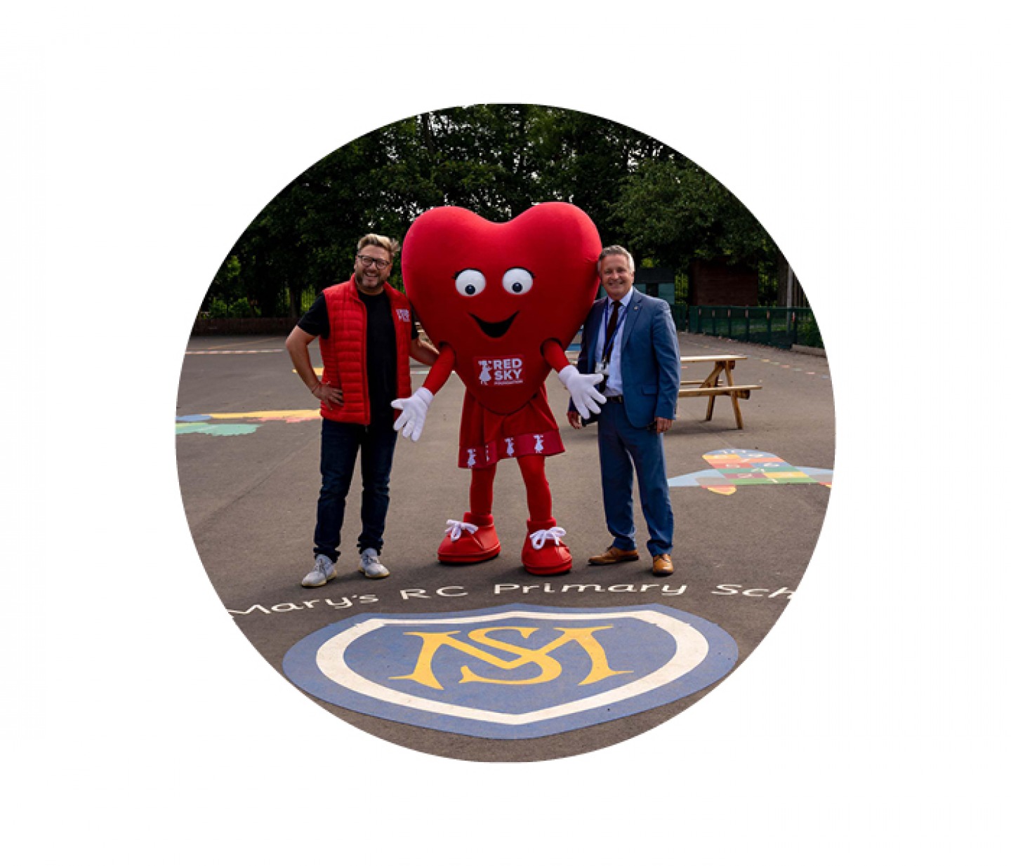 2 men smiling with red sky mascot