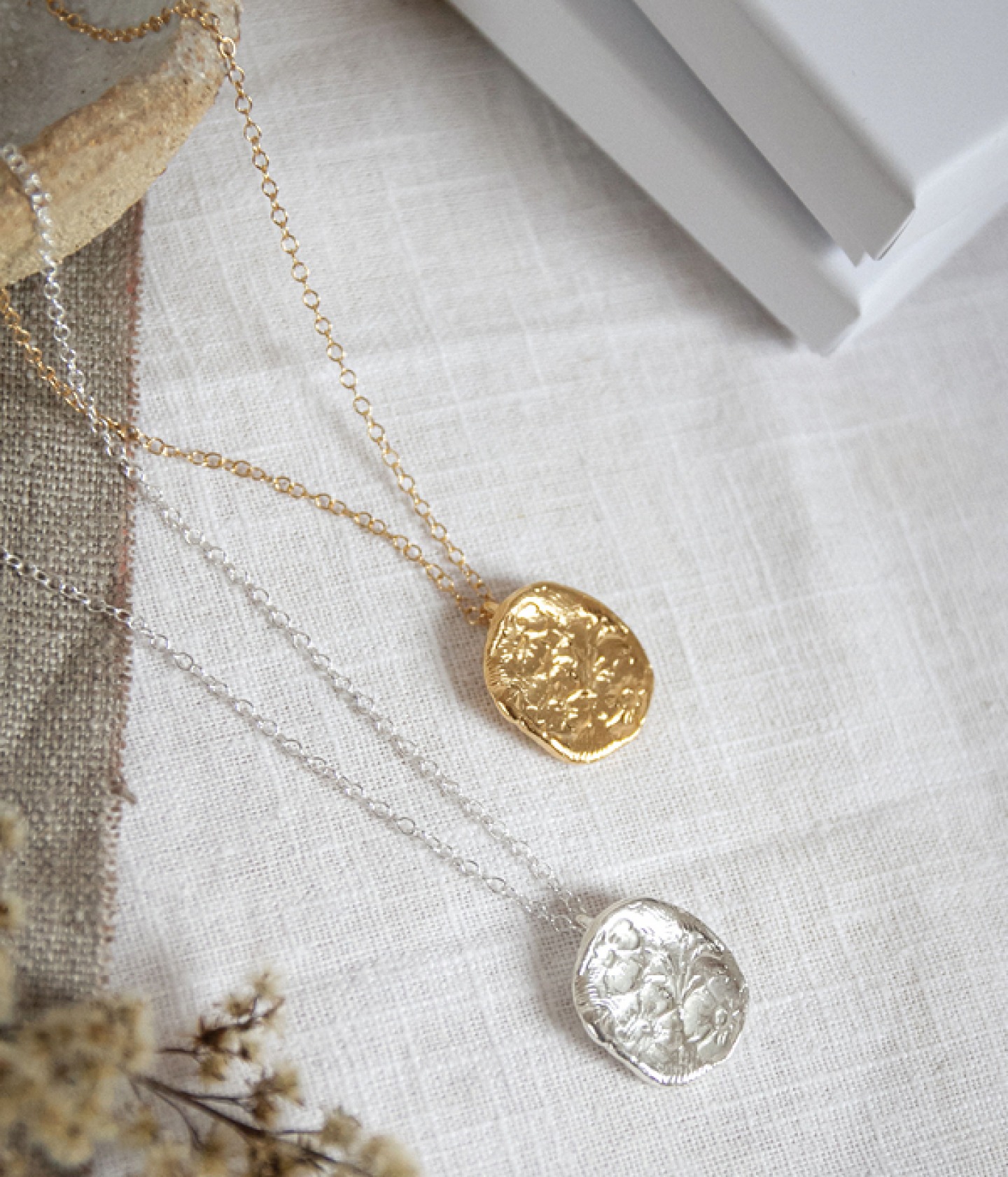 one gold and one silver pendant necklace