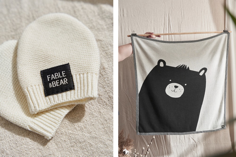 cream knitted hat and a bear printed blanket