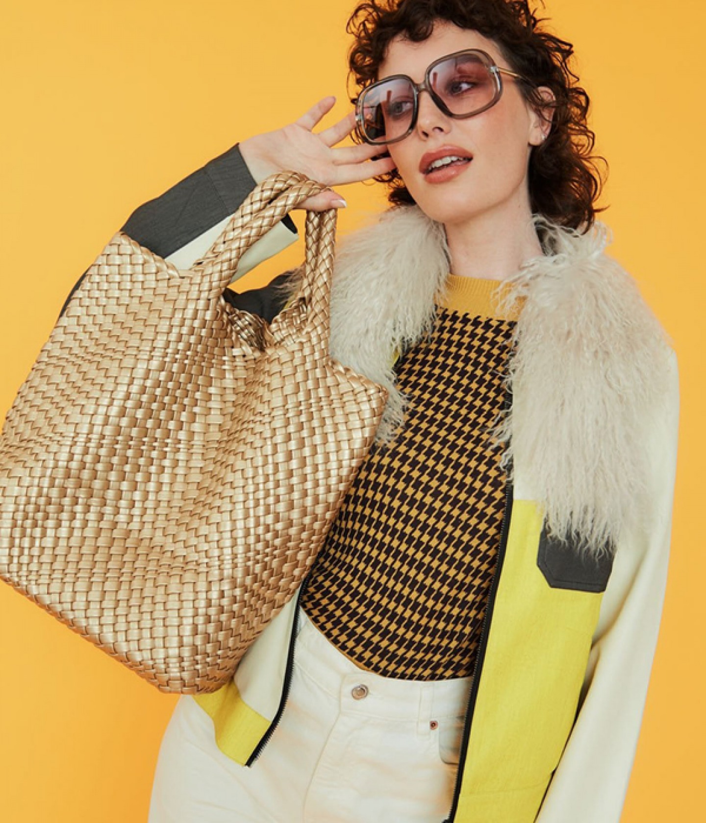 Model holding Handknitted leather gold tote