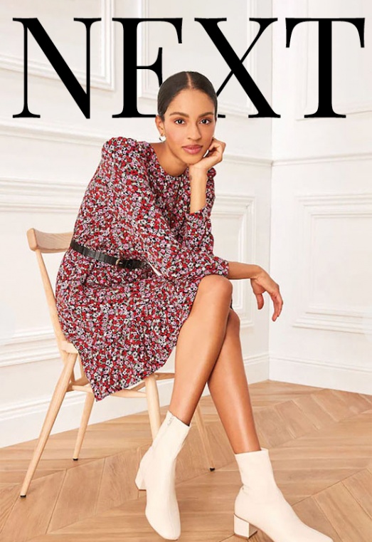 model sat on a chair modelling white ankle boots