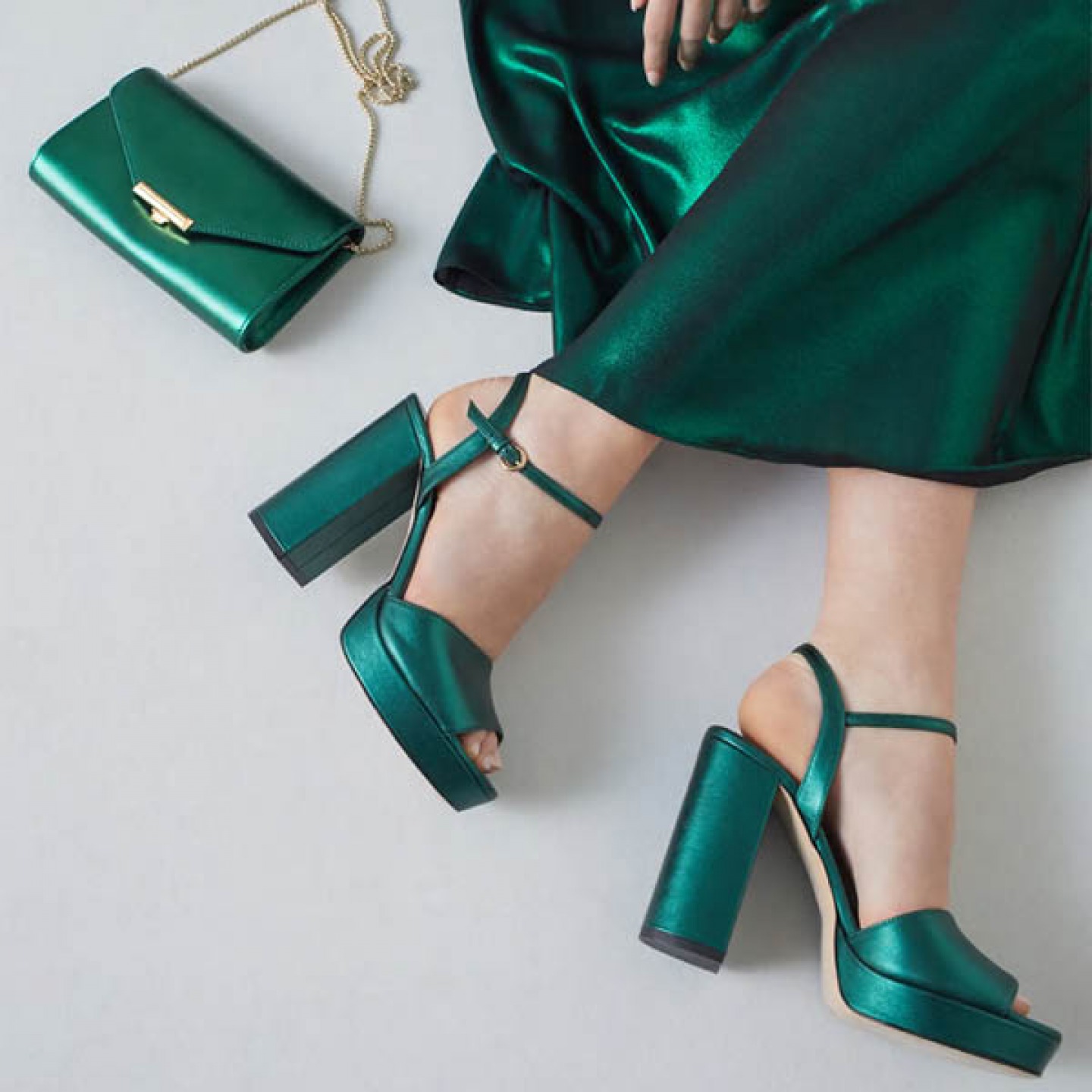 Model wearing Metallic green platform sandals with matching bag and Dress