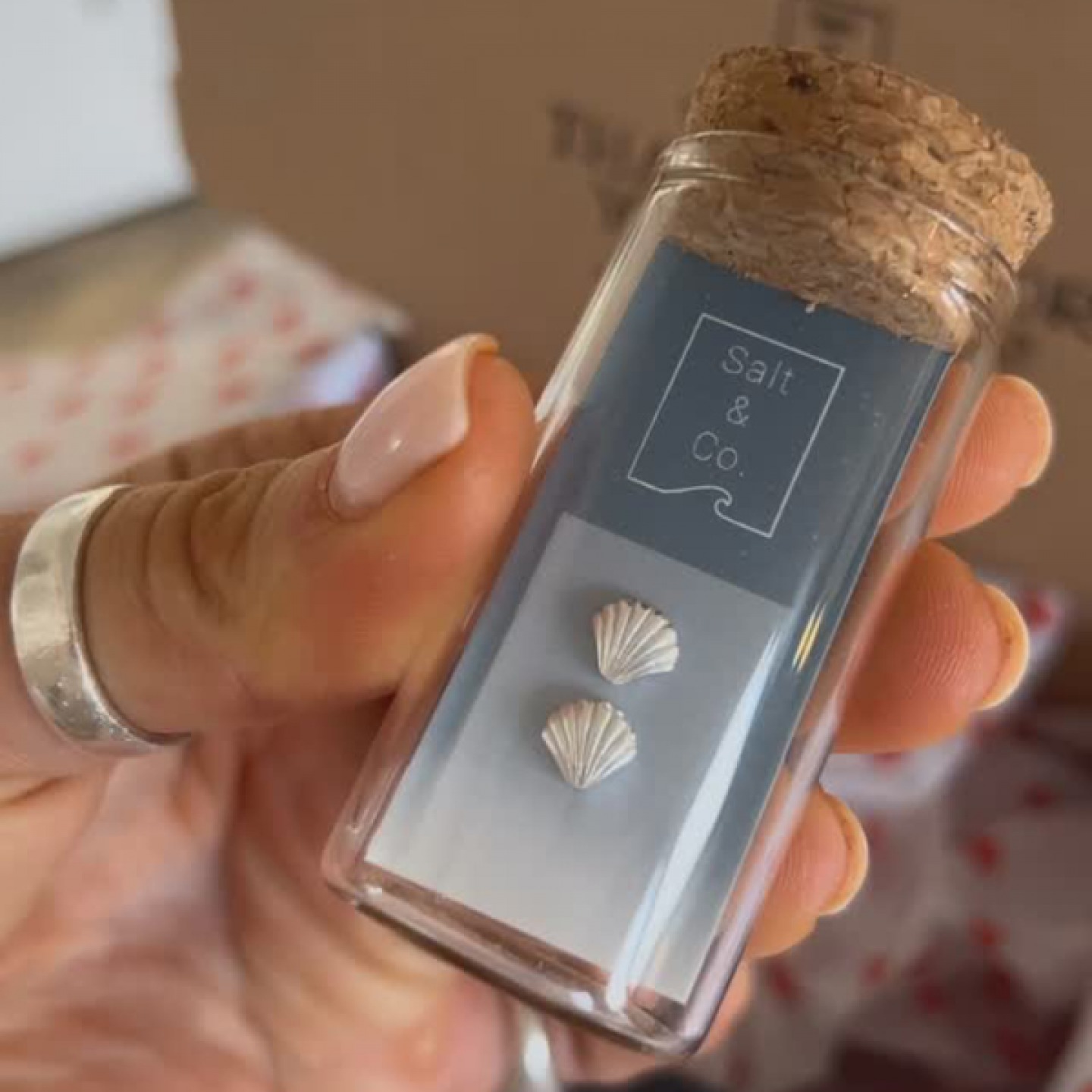 close up of shell earring in a bottle