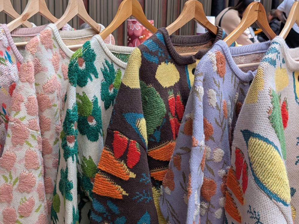 Brightly coloured cardigans hanging in a row