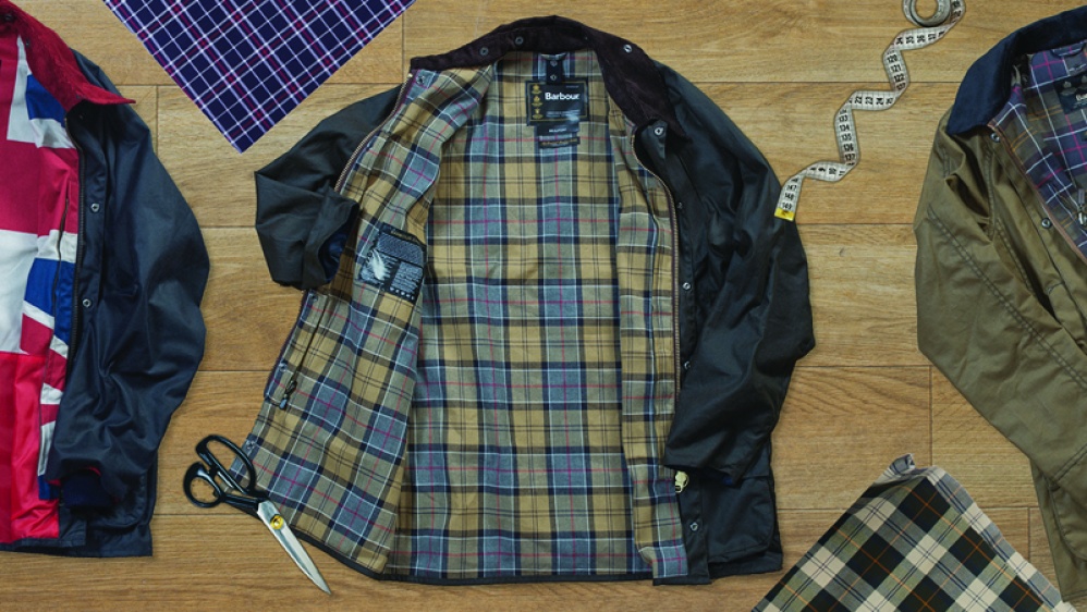 Barbour jackets lying flat with scissors, tape and fabric