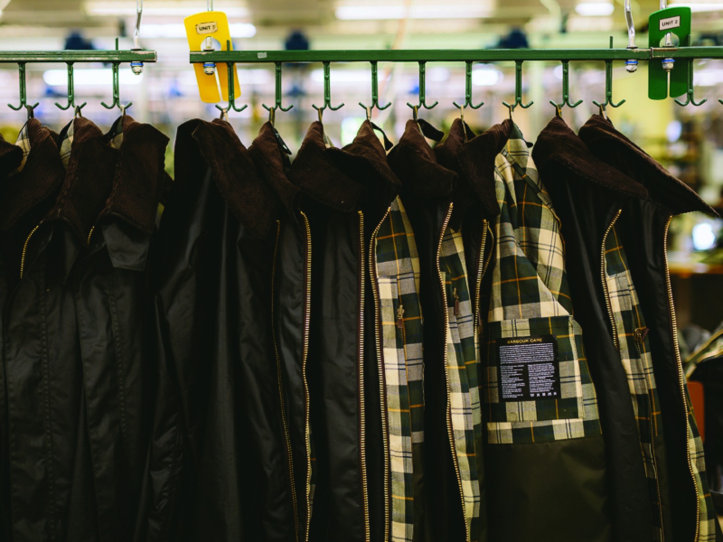 wax jackets hanging on rails