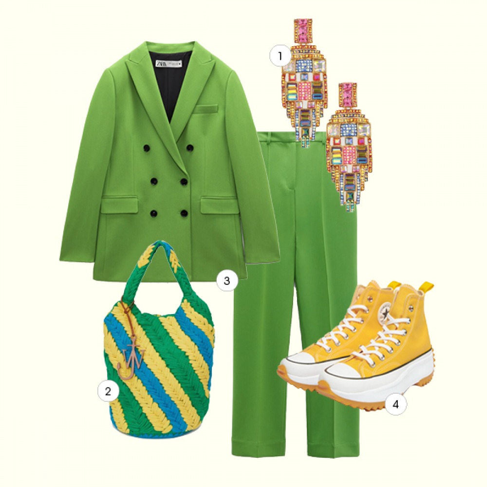 colourful outfit: green suit, yellow green and blue bag, colourful earrings and yellow shoes