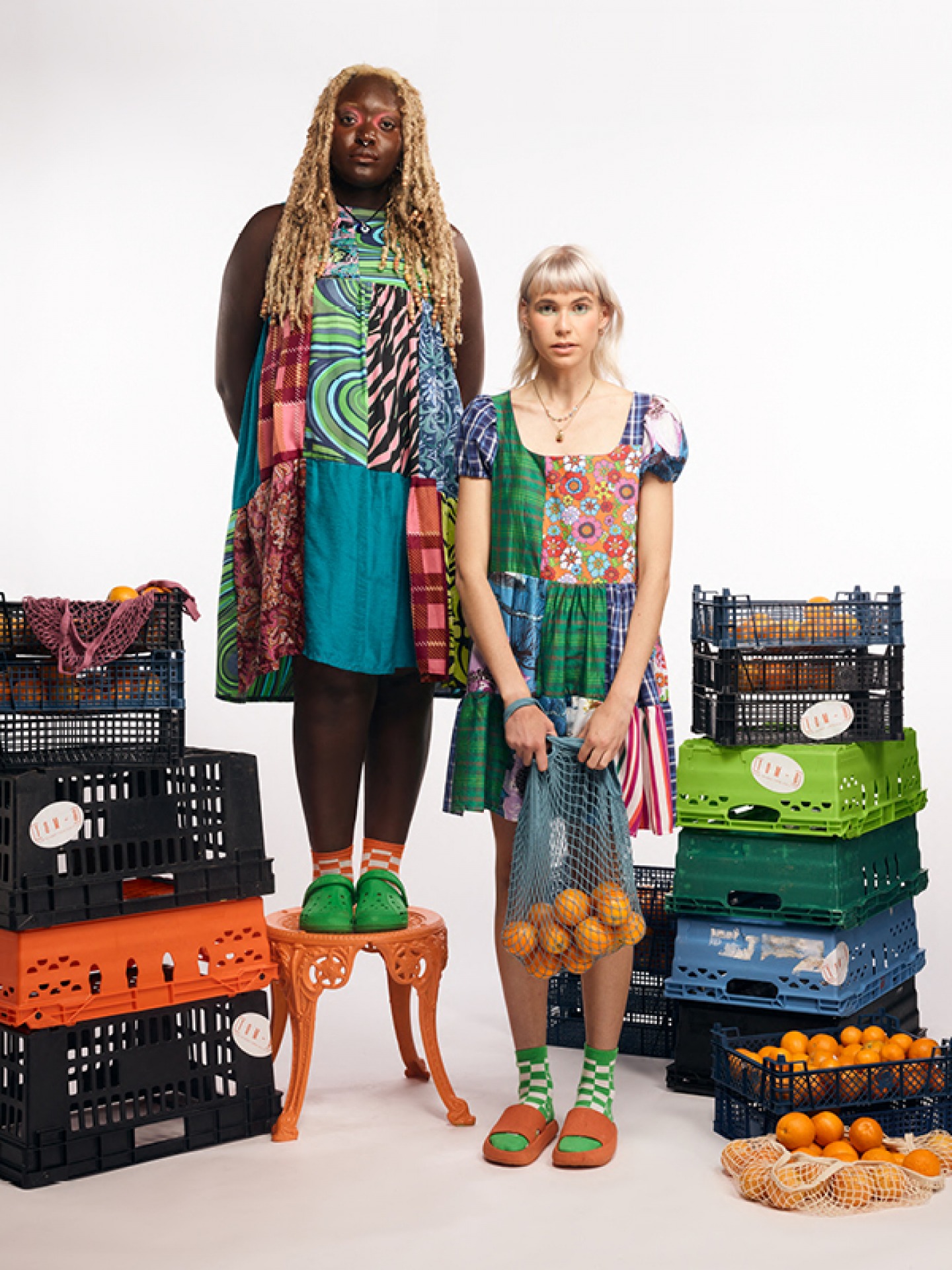 Models posing in Sarahs Clothes Surrounded by crates of Oranges