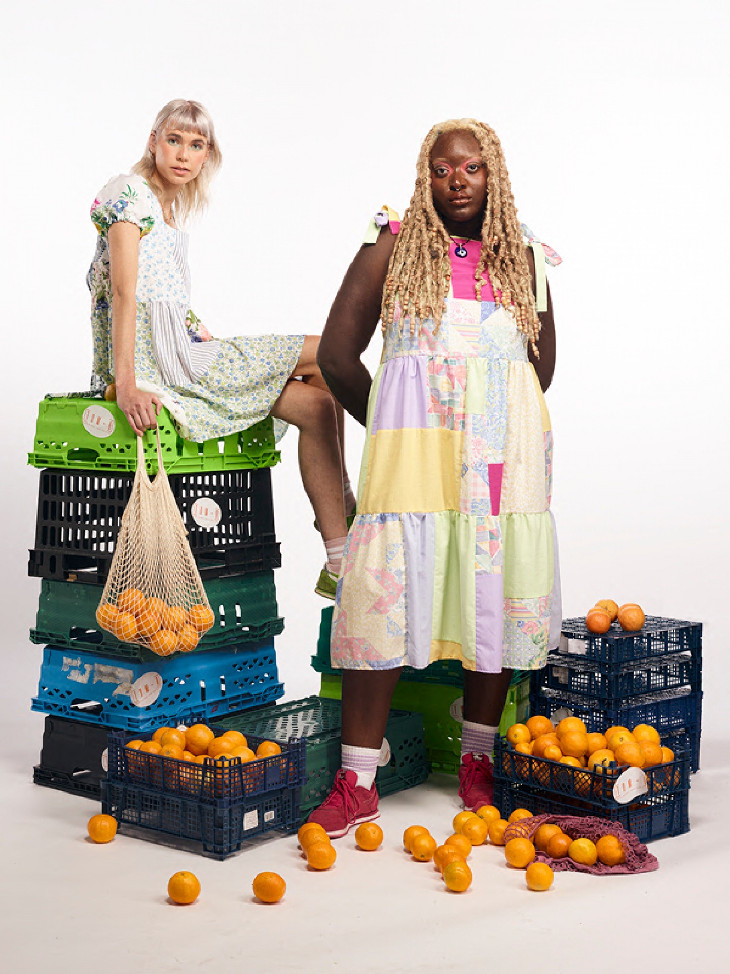 Models posing in Sarahs Clothes Surrounded by crates of Oranges