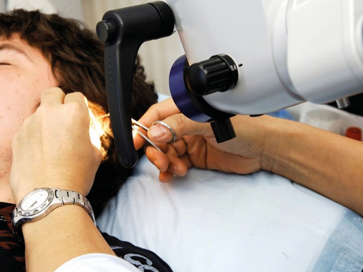 someone having a ear procedure done by a professional
