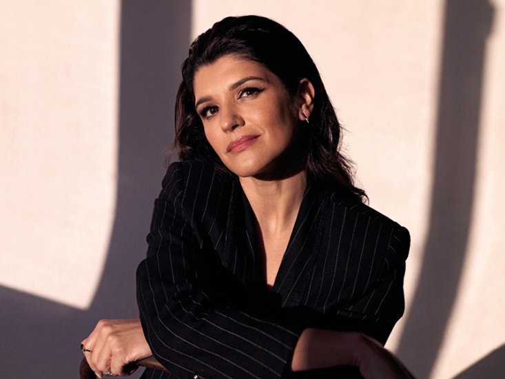 woman posing in a black pin striped suit