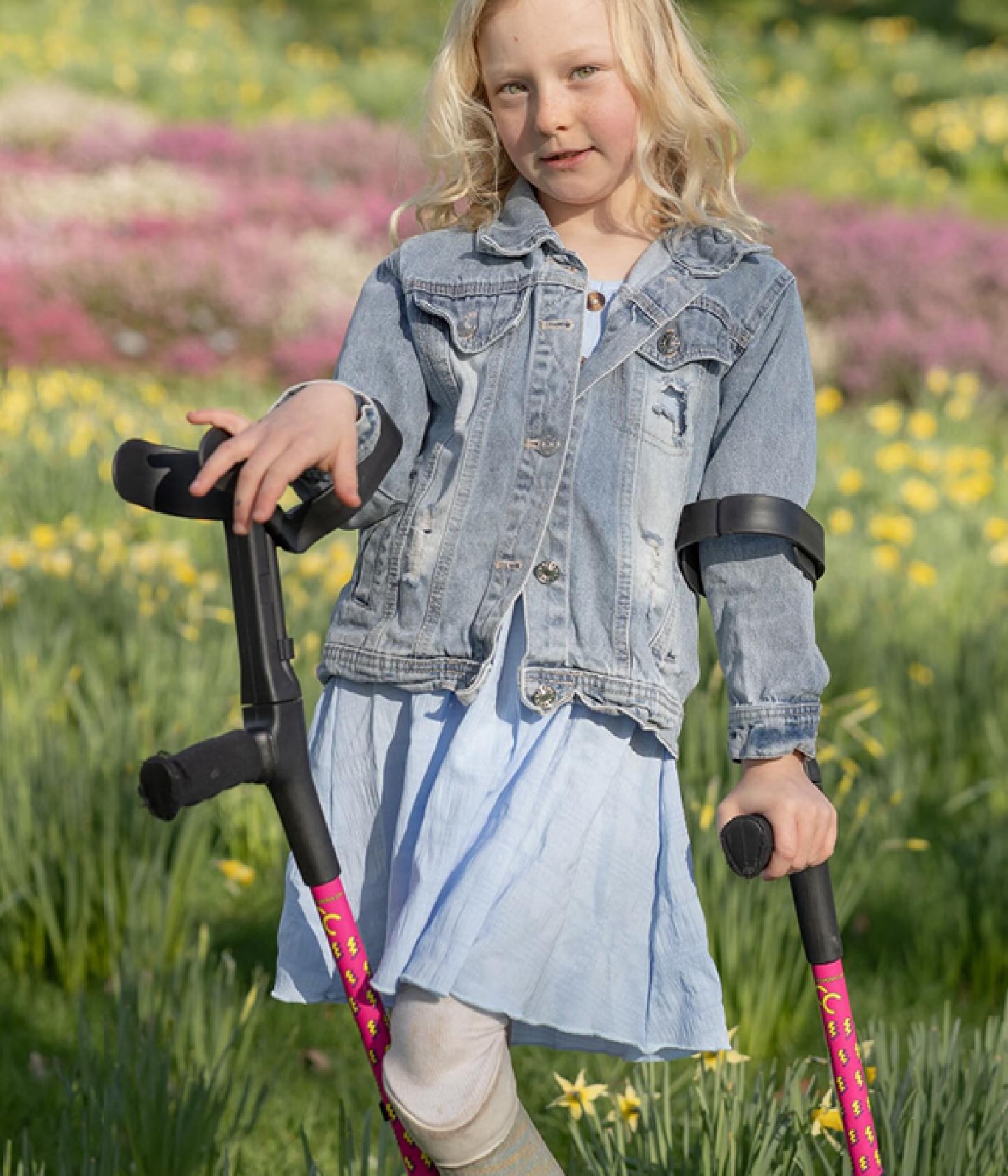 Ypung girl with prosthetic leg using crutches