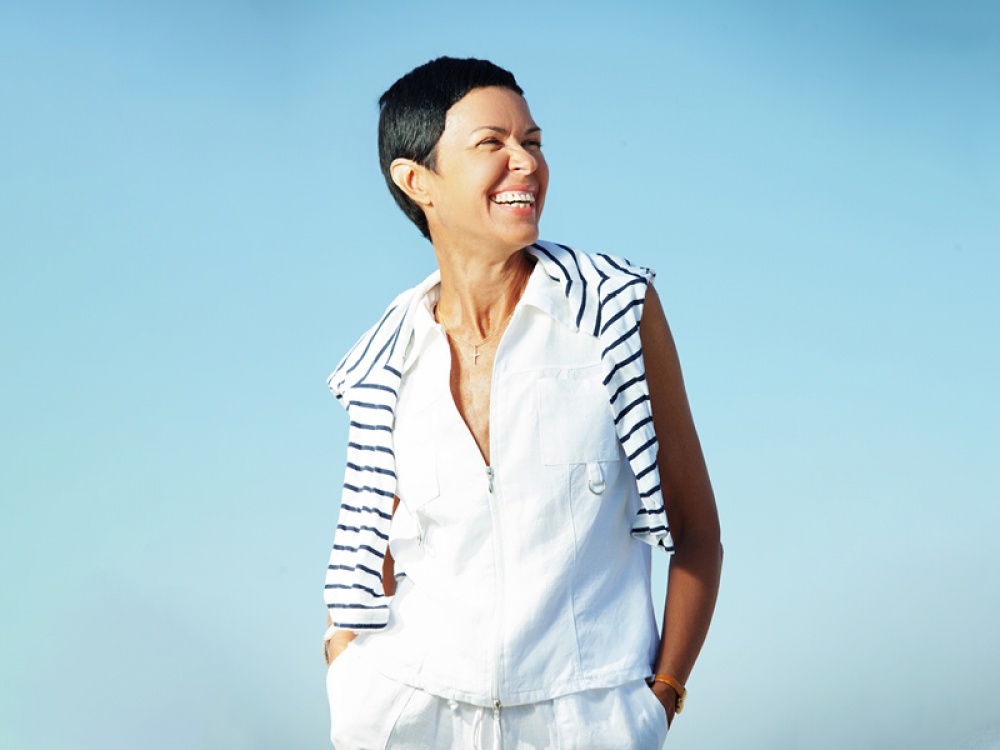 middle aged model in a white on-trend waistcoat smiling