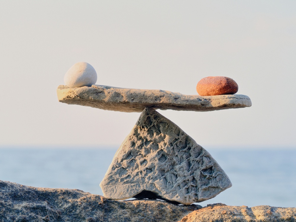 Rocks in the shape of scales balancing two stones